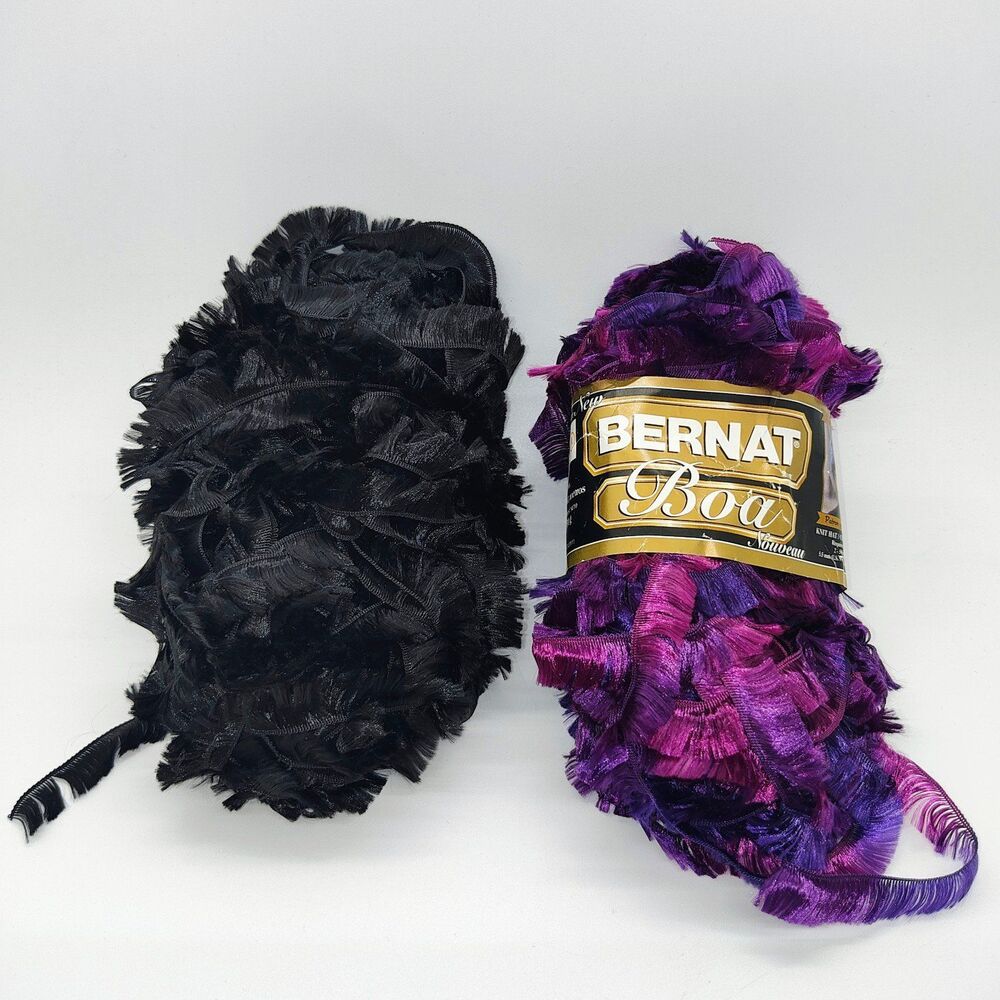 Two packs of 71 yards each, Bernat "eyelash" boa fabric, purple and black.
